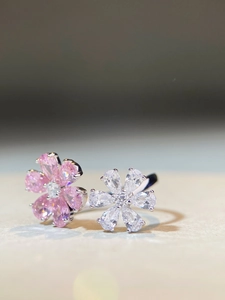Macro view of adjustable s925 silver ring featuring pink and clear pear-cut floral zircon