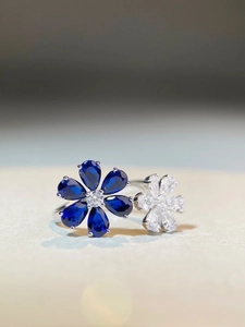 Macro shot of 925 silver ring featuring blue and clear zircon floral petals