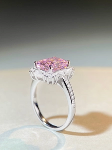 Macro detail of rectangle pink zircon ring with diamond halo in 925 sterling silver