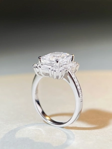Detailed side view of radiant cut emerald shape ring with halo diamonds in silver