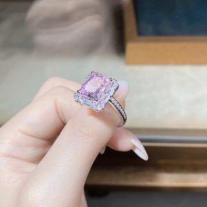 Close-up of luxury 925 silver ring with emerald-cut pink zircon and surrounding diamonds