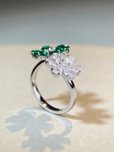 Macro detail of S925 silver ring featuring white and green zircon flower petals