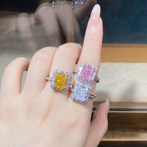 Close-up of luxury sterling silver rings featuring radiant-cut yellow, pink, and white stones