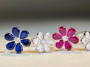 Macro detail of 925 silver flower rings with colorful pear-cut zircon petals and crystals