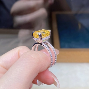 Detailed close-up of S925 silver ring with oval yellow diamond and double band design