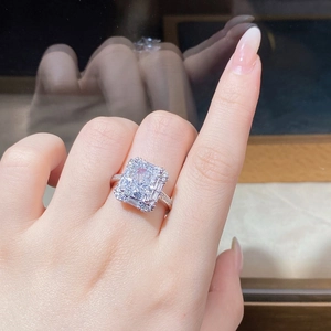 Macro shot of Radiant cut silver ring with halo setting and micro-pave band details