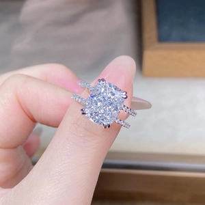 Detailed view of a cushion-cut gemstone ring with dual-row pavé diamond band setting