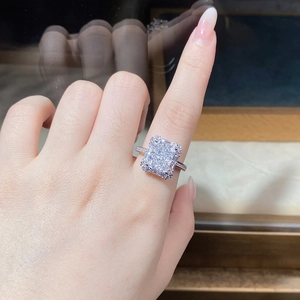 Close-up of radiant cut ice flower sterling silver ring worn on model's hand