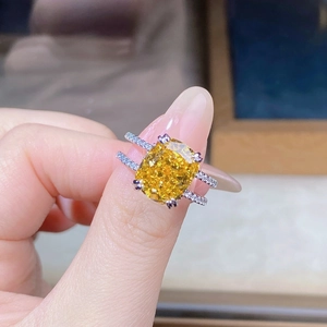 Macro shot of cushion cut yellow gemstone ring with pavé double band in S925 sterling silver