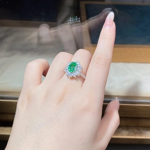 Detailed view of a S925 silver ring with sunflower-shaped green stone and pavé zircons