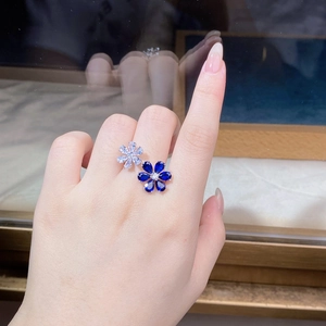 Detailed view of 925 silver flower ring with blue sapphire and white zircon gems