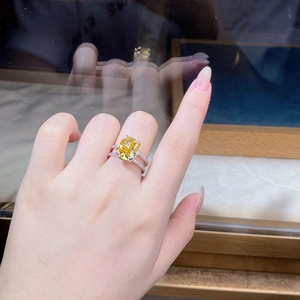 Close-up of luxury S925 silver ring featuring a large cushion-cut yellow gemstone and side diamonds