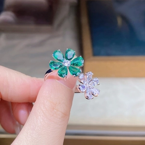 Macro shot of S925 silver double flower ring featuring green and white pear-cut zircon