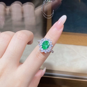 Macro detail of S925 silver sunflower ring featuring an oval green gemstone and zircons