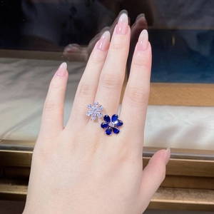 Detailed view of sterling silver double flower ring with blue and white zircon stones