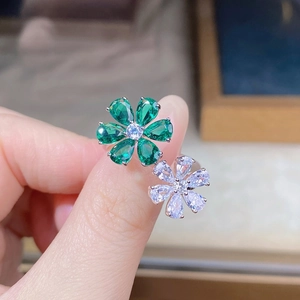 Macro view of S925 silver ring featuring pear-cut green and white zircon flower design