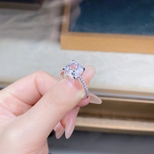 Close-up of square cut white zircon ring with pavé setting in 18K white gold plating