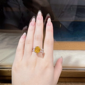 Macro detail of a 925 silver ring featuring a large cushion-cut yellow zircon main stone