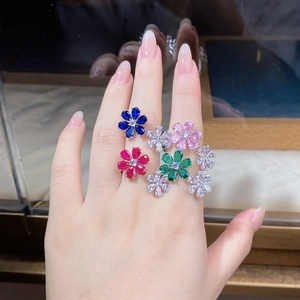 Close-up of hand wearing colorful teardrop zircon flower rings in 925 silver