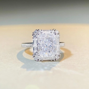 Radiant cut silver ring featuring a large crystal center and halo of sparkling diamonds