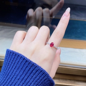 Close-up of S925 sterling silver ring with oval ruby and micro-pave diamonds