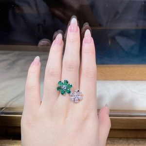 Close-up of S925 silver double flower ring with emerald and white zircon stones