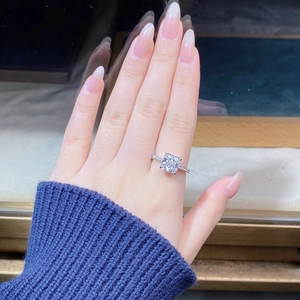 Macro view of square-cut white zircon ring with four-prong setting on a hand