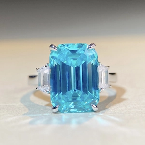 Emerald cut light blue zircon ring in 925 sterling silver with trapezoid side stones