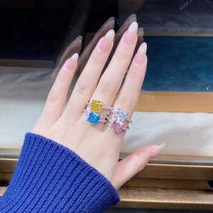 Macro shot of silver rings featuring square-cut colored stones and pavé set bands