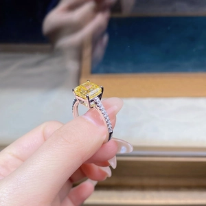 Macro shot of s925 silver ring with radiant yellow zircon and pavé side stones