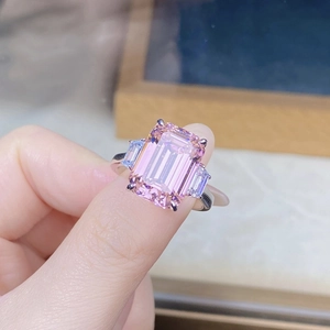 Macro shot of 925 silver ring featuring a large pink emerald-cut center stone and side diamonds