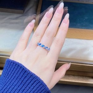Detail of S925 silver ring with blue rectangle gems and white zircon on hand