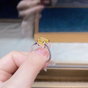 Macro shot of square yellow zircon ring with micro-paved diamonds on sterling silver band