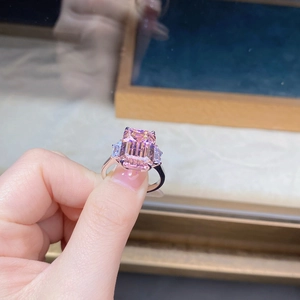 Macro view of emerald-cut pink zircon ring with three-stone setting in 925 silver