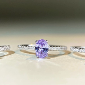 Macro shot of oval purple gemstone ring with micro-pave diamonds in S925 sterling silver
