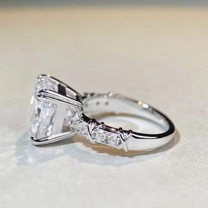 Macro shot of cushion cut gemstone ring with criss-cross pave diamond band detail