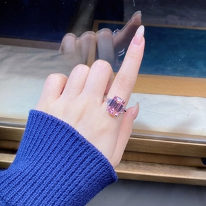 Detailed view of an emerald cut pink zircon ring set in sterling silver on a hand