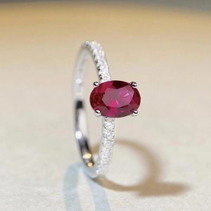 S925 sterling silver ring featuring a large oval pigeon blood ruby and pavé diamonds
