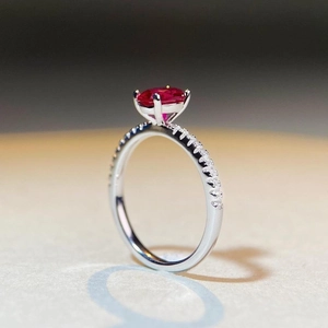 Elegant S925 silver ring with oval pigeon blood ruby and pavé set side stones