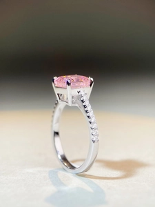 Macro side view of rectangular pink gemstone ring with four-claw silver setting