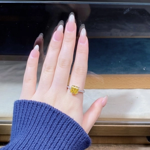Macro view of a square yellow gemstone ring with pavé diamonds on S925 silver band