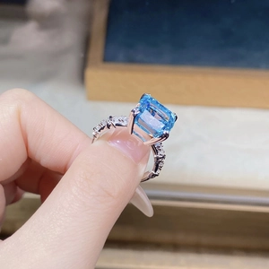 Macro detail of S925 silver ring with rectangular aquamarine gemstone and pavé accents