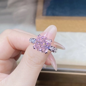 Macro detail of cushion cut pink diamond ring with white gold plating on silver band