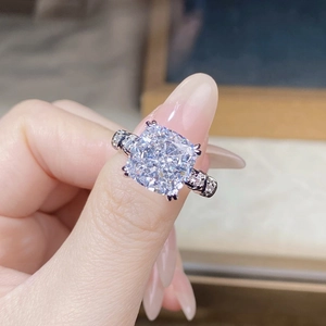 Macro shot of cushion cut zircon ring with micro-paved diamonds on S925 silver band
