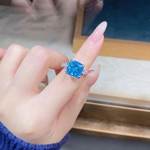 Macro view of S925 silver ring featuring a large square-cut vibrant blue stone on finger