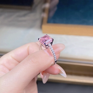 Macro shot of s925 silver ring featuring pink radiant cut stone and pavé diamond band