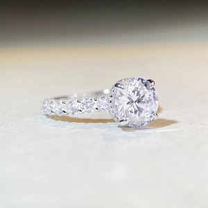 Elegant 3ct moissanite sterling silver ring with four-prong setting and side accents