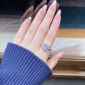 Macro shot of cushion-cut zircon ring with micro-pave setting on a silver-plated band