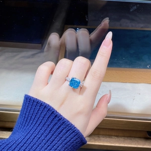 Macro shot of S925 silver cushion cut aquamarine ring with pavé diamond halo