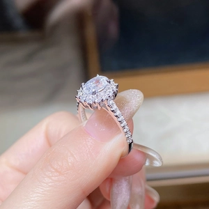 Macro shot of S925 sterling silver ring showing oval moissanite and pave side stones